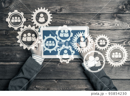 Concept of teamworking and connection with gears mechanism and tablet pc Concept of teamworking and connection with gears mechanism and tablet pc 93854230