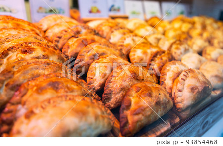 freshly baked empanadas with different fillings for sale 93854468