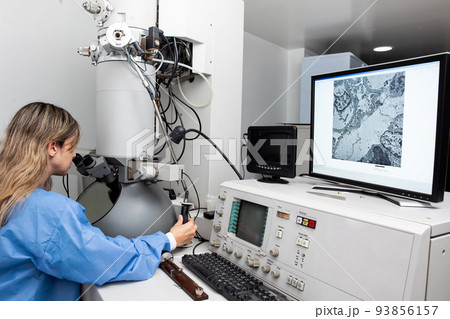 Young female scientist working at the laboratory with an electron microscope 93856157