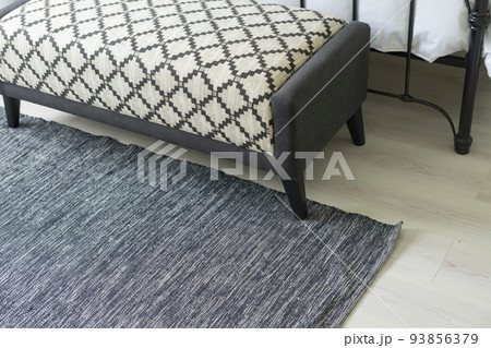 Grey carpet on floor in bedroom with bench. 93856379