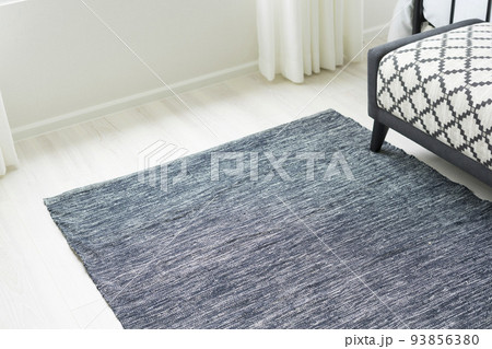 Grey carpet on floor in bedroom with bench. 93856380