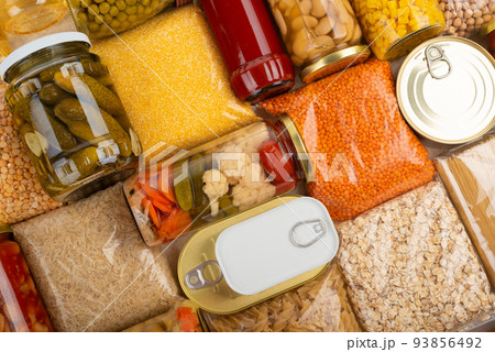 Emergency survival groceries on kitchen table closeup flat lay Emergency survival groceries on kitchen table closeup flat lay 93856492