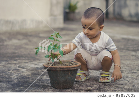 Cute Little baby boy with Flower tub sitting at outdoor 93857005