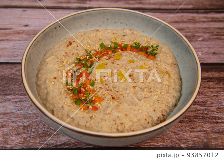 Traditional arabian eggplant dip baba ganoush with herbs and smoked paprika on a wooden background 93857012