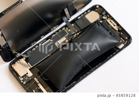 Swollen smartphone battery. Damaged smartphone battery Swollen smartphone battery. Damaged smartphone battery 93859128