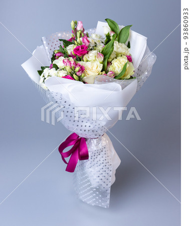 Bouquet of roses, eustoma and irises on a blue background. Bouquet of roses, eustoma and irises on a blue background. 93860933