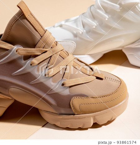 Close up of different models of women's sports shoes on colored background. Close up of different models of women's sports shoes on colored background. 93861574