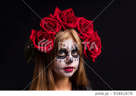 Portrait of teenager girl in a witch costume, on studio background. halloween make up Portrait of teenager girl in a witch costume, on studio background. halloween make up 93861676