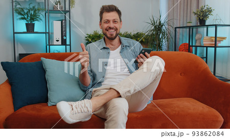 Handsome young man at home use smartphone typing browsing, wow yes found out great big win celebrate 93862084