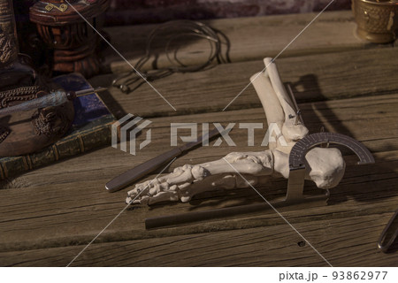 Old doctor's desk. still life of instruments and bone parts typical of a doctor of the time. 93862977
