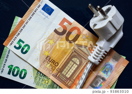Power plug and euro money, domestic electric cable on European banknotes, top view 93863010