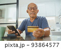 Asian Senior man making online shopping 93864577