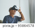 Excited Asian Senior man wearing VR goggles 93864578