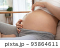 Woman playing belly with fingers 93864611