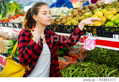 Portrait of nice young woman buying fresh apples 93865375