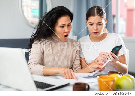 Worried LGBT couple working with papers Worried LGBT couple working with papers 93865647