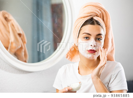 Young woman applying natural homemade facial mask Young woman applying natural homemade facial mask 93865885