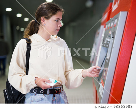 Woman buying a ticket to the subway train Woman buying a ticket to the subway train 93865988