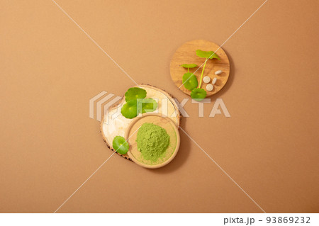 Fresh Gotu kola and Gotu kola (Centella Asiatica) powder and Capsules in wooden dish useful ingredients in skin care products.. Flatlay image for design. 93869232