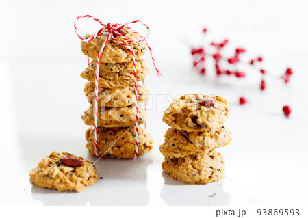 Oatmeal cookies with black sesame and almond with red and white color rope. 93869593