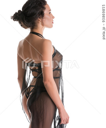 Slim brunette in sexy silk dressing-gown rearview 93869855