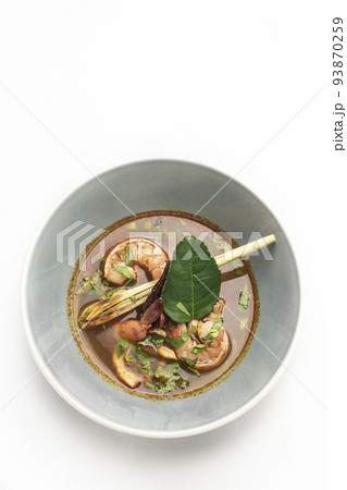 thai tom yam kung spicy soup with prawns on white background 93870259
