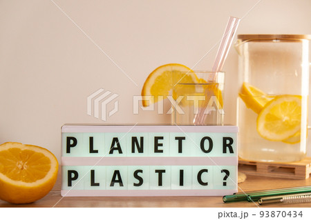 Lightbox with text PLASTIC OR PLANET Glass of water with fresh lemon juice with Reusable glass Straws Detox cold tonic water with sunny lemon slices Low-waste lifestyle Eco-Friendly Drinking Straw Lightbox with text PLASTIC OR PLANET Glass of water with fresh lemon juice with Reusable glass Straws Detox cold tonic water with sunny lemon slices Low-waste lifestyle Eco-Friendly Drinking Straw 93870434