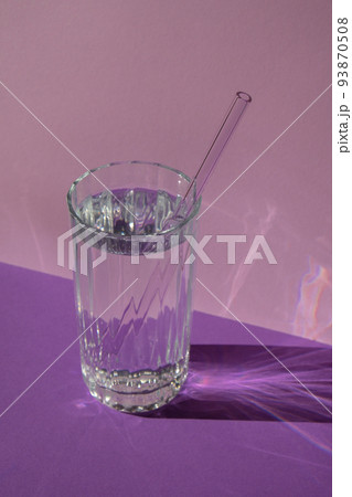 Reusable glass Straws in Glass with water on purple violet background Eco-Friendly Drinking Straw Set with cleaning brush. Zero waste, plastic free concept Reusable glass Straws in Glass with water on purple violet background Eco-Friendly Drinking Straw Set with cleaning brush. Zero waste, plastic free concept 93870508
