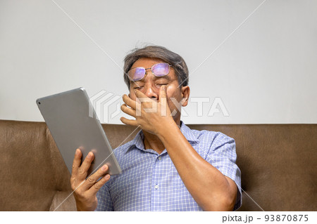 Senior asian man has eyestrain and fatigue Senior asian man has eyestrain and fatigue 93870875