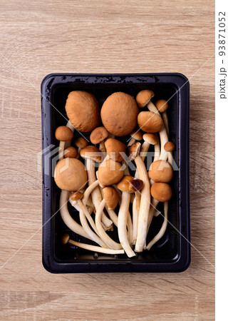 Fresh yanagi matsutake mushroom in package on wooden background Fresh yanagi matsutake mushroom in package on wooden background 93871052