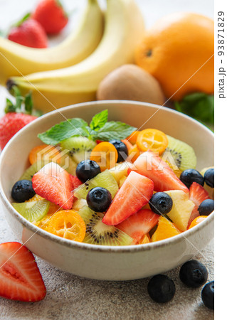 Healthy fresh fruit salad in a bowl Healthy fresh fruit salad in a bowl 93871829