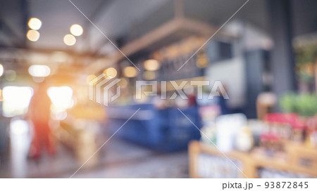 Blurred background shopping mall light bokeh business event in retail store. Blurry abstract background of store grocery. Blur Convention hall center audience present display goods products on shelf. 93872845