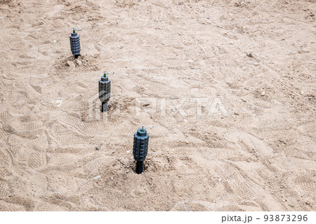 hand fragmentation grenade mounted on the sand in a stretch hand fragmentation grenade mounted on the sand in a stretch 93873296
