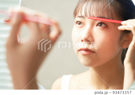 鏡の前で髪の毛を整える若い女性 ヘアケア ビューティー イメージ 鏡の前で髪の毛を整える若い女性 ヘアケア ビューティー イメージ 93873357