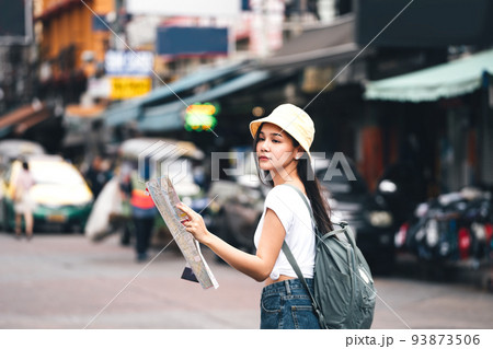Young adult asian traveller explore searching map when sightseeing. At landmark Khaosan Young adult asian traveller explore searching map when sightseeing. At landmark Khaosan 93873506