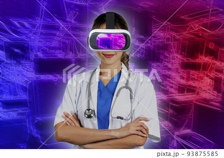 Female doctor wearing 3D virtual reality glasses standing with her arms crossed. 93875585