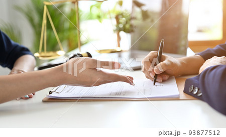 A professional female lawyer meets with her client in private to consult to sign the contract 93877512