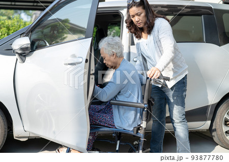 Asian senior or elderly old lady woman patient sitting on wheelchair prepare get to her car, healthy strong medical concept. 93877780