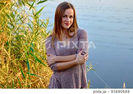 Portrait of a cute young woman with brown fair hair and golden autumn leaves Portrait of a cute young woman with brown fair hair and golden autumn leaves 93880688