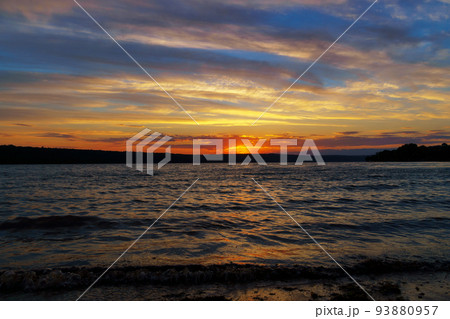 sunset over the lake, bright sun reflected in the waves, glare on the water, beautiful summer landscape sunset over the lake, bright sun reflected in the waves, glare on the water, beautiful summer landscape 93880957