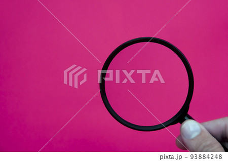 Hand holding magnifying glass with space customizable for text or ideas. Copy space 93884248