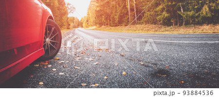 Red car on the autu asphalt road in countryside 93884536