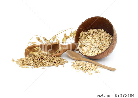 Oats grains and oat groats rolled into flakes 93885484