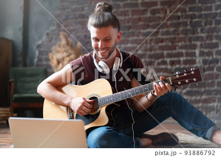 Male musician playing acoustic guitar. Male musician playing acoustic guitar. 93886792