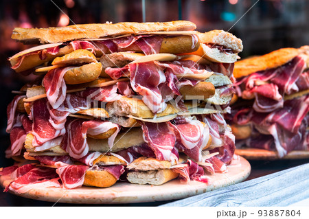 mouth watering sandwiches with jamon laid out in a slide on shop window mouth watering sandwiches with jamon laid out in a slide on shop window 93887804