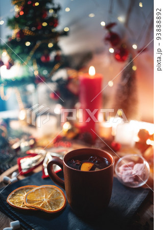 mulled red wine gluhwine in cup with orange, christmas decor table with candles mulled red wine gluhwine in cup with orange, christmas decor table with candles 93888892