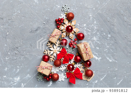 Christmas tree made from colored ball decoration on colored background, view from above. New Year minimal concept with copy space 93891812