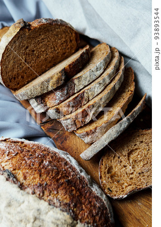 Freshly baked bread with a golden crust close up. Freshly baked bread with a golden crust close up. 93893544