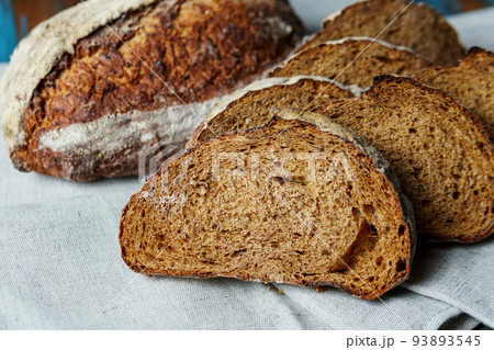 Freshly baked bread with a golden crust close up. Freshly baked bread with a golden crust close up. 93893545