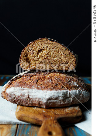 Freshly baked bread with a golden crust close up. Freshly baked bread with a golden crust close up. 93893546